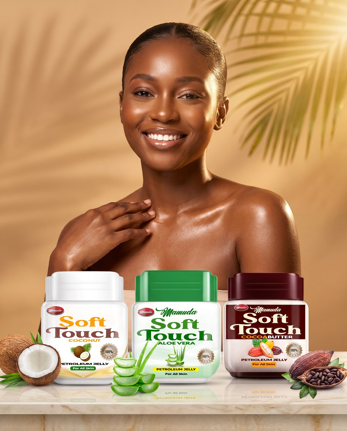 A radiant young Nigerian woman with glowing skin smiling above the three Mamuda Soft Touch petroleum jelly jars — Coconut, Aloe Vera and Cocoa Butter — on a marble ledge with a cracked coconut, aloe slices and a cacao pod